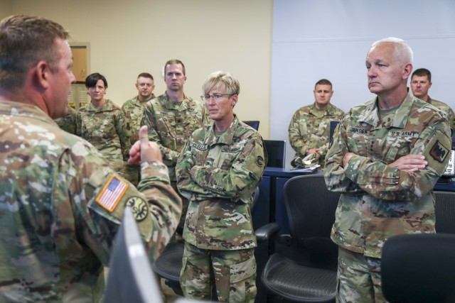 Army Lt. Gen. Jon Jensen, the director of the Army National Guard, right, and Brig. Gen. Laura Clellan, the Adjutant General of Colorado, center, speak with Soldiers in the Missile Defense Element at Schriever Space Force Base, Colorado, July 26, 2021. Jensen visited the 100th Missile Defense Brigade of the Colorado Army National Guard in Colorado Springs to learn more about the unit and its mission to defend the United States and designated areas from long-range ballistic missile attacks. (U.S. Army National Guard photo by Staff Sgt. Zach Sheely)