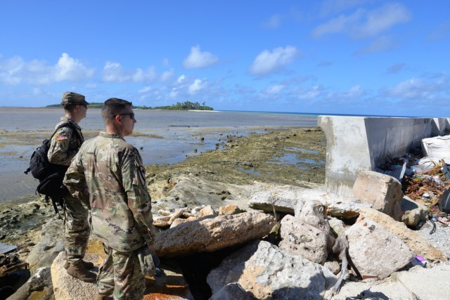 U.S. Army Garrison-Kwajalein Atoll Host Nation Director Lt. Col. Daniel Young, left, and USAG-KA Commander Col. Thomas Pugsley, right, view a seawall on western Enniburr during Pugsley's first visit to the island July 24, 2021. Built with funding...