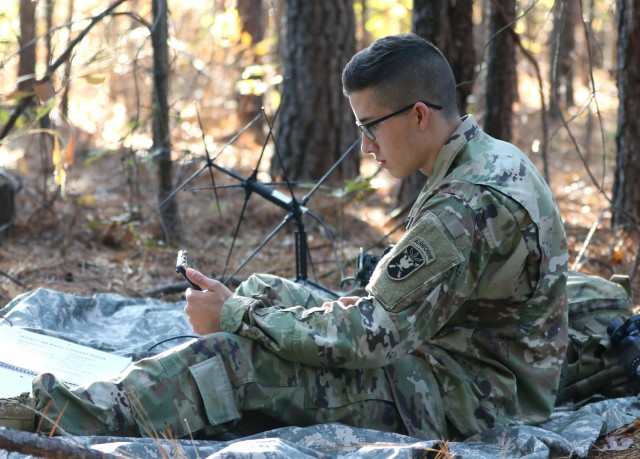 A student assigned to the U.S. Army John F. Kennedy Special Warfare Center and School trains using a PDA-184 computer and an AN/PRC-117G satellite radio during training at the Yarborough Training Complex. Cooperative research and development agreements provide the Army with potential technologies of which it may not have been aware, and offer the Army the opportunity to explore how such technologies can be applied to the battlefield. (U.S. Army photo by K. Kassens)