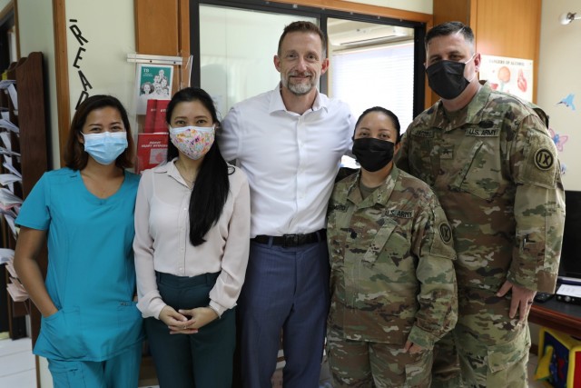 From left, Nurse Elve Khadine D. Bandrang RN, Dr. Doyeth De Los Reyes, U.S. Ambassador Kevin Blackstone, Lt. Col Hope Hashimoto, and Sgt. Nathanial Jacobsen at the U.S. Embassy Health Unit on July 28, 2021.  Ambassador Blackstone and the U.S. Embassy Health Unit medical team pose with the soldiers from the 9th Mission Support Command's Task Force Oceania who delivered much-needed medical supplies to the embassy. (U.S. Army Reserve photo by Sgt. Teresa Cantero)