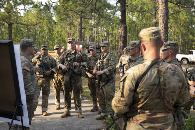 Twelve competitors representing Army Centers of Excellence from across the nation take a break from a Series of round robin events while receiving day and night land navigation instructions for the next competition event July 28, 2021. The week-long event was hosted by Fort Jackson and the title of best of the best was claimed by Sgt. 1st Class Travis Burkhalter, center, a drill sergeant assigned to the U.S. Army Drill Sergeant Academy, Fort Jackson. (Photo by Sgt. Vincent Wilson)