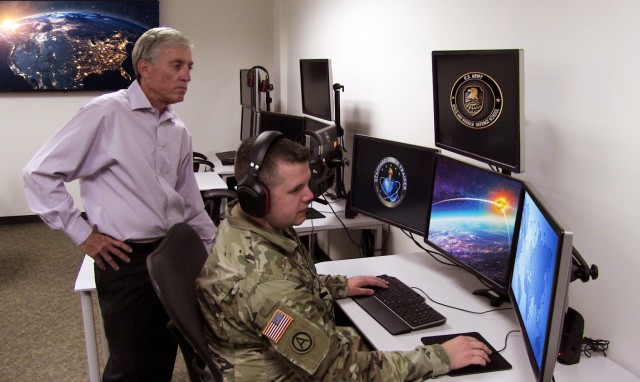 Clem Morris, Missile Defense Training Division chief at the Space and Missile Defense School, trains Sgt. 1st Class Kacee Love on the new Mission Specific Vendor Plug-in Command and Control, Battle Management and Communications Training System, Aug. 2, in Colorado Springs, Colorado. (U.S. Army photo by Daniel Santistevan)