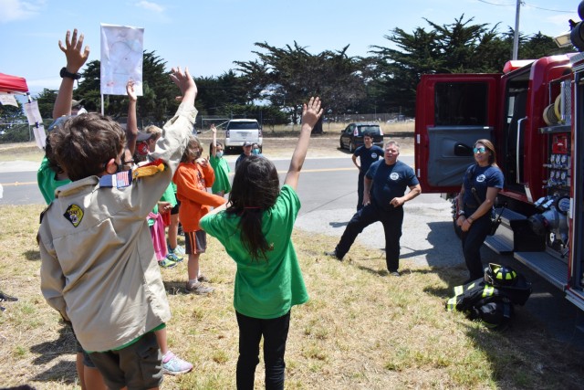 Cub Scouts from the Monterey area ask questions of firefighters with the Presidio of Monterey Fire Department during the Monterey Cub Scout Camp at the Presidio of Monterey, Calif., July 29.