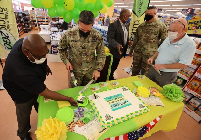 Fort Knox Garrison Commander Col. Lance O’Bryan serves the first piece of cake to Fort Knox Commissary store administrator Markel Lindsey.