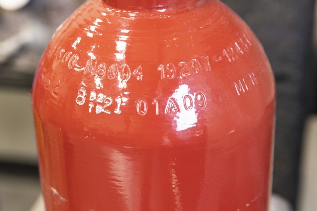 The unique ANAD serial number and date has been stamped on a fire bottle.