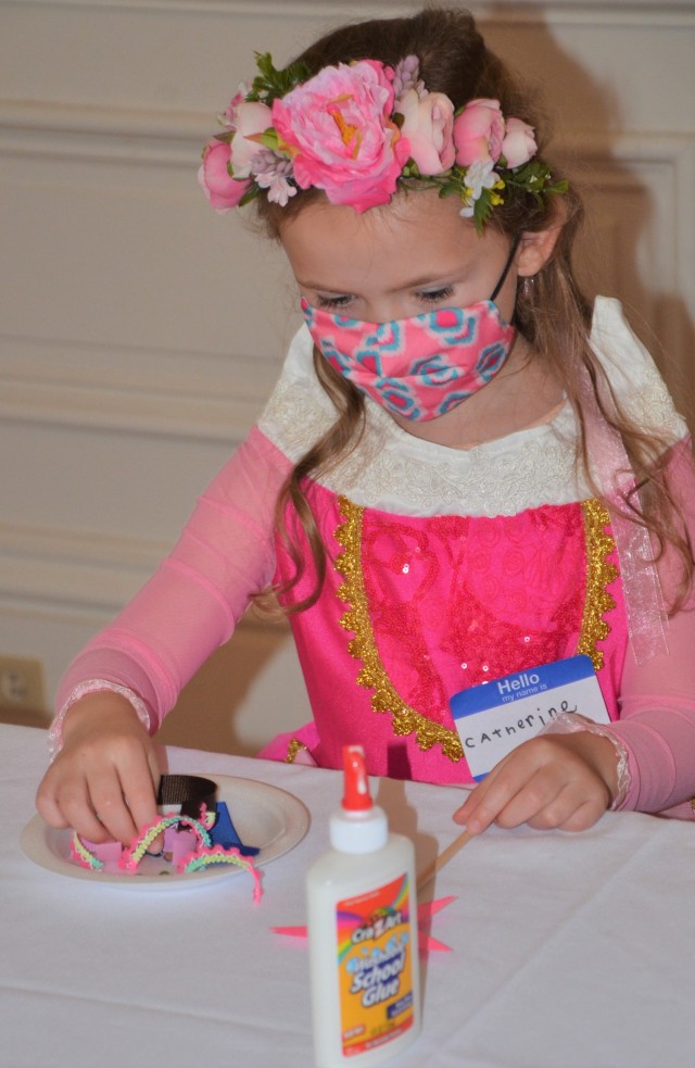 Princess Catherine adds enchanting elements to her wand at the “Storytime with Princesses” event held at Rock Island Arsenal, Illinois, July 17.