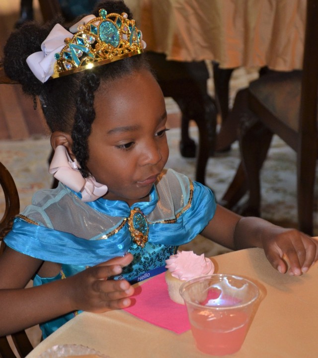 Princess Naomi partakes in the delicious treats at the refreshment table set up for the “Storytime with Princesses” event held at Rock Island Arsenal, Illinois, July 17.
