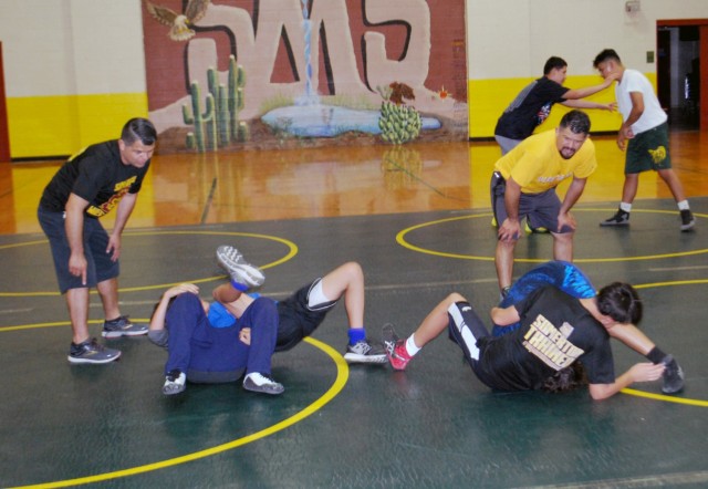Brothers Arturo and Carlos Anaya have served as volunteer wrestling coaches for the Somerton, Ariz. Parks and Recreation Department since 2007. The men, both test officers for U.S. Army Yuma Proving Ground, wrestled in the exact same gymnasium as adolescents, and helped Somerton Middle School students earn a state championship earlier this year.