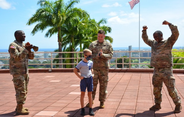 At the Physician Assistant Recognition Award Ceremony, Command Sergeant Major Diamond Hough does the Army Medicine call and response with Maj. A.J. Galdi&#39;s son Avery along with U.S. Army Surgeon General Lt. Gen Scott Dingle.