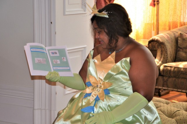 Princess Tiana (Alexis Boeh-Peterson), spins some magic with a story to her group of princes and princesses during the “Storytime with Princesses” event held at Rock Island Arsenal, Illinois, July 17.