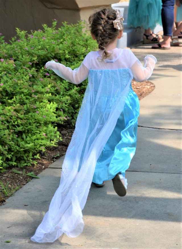 A mini-Elsa runs to Quarters 1 to meet up with her royal friends at the Family, Morale, Welfare and Recreation “Storytime with Princesses” event held at Rock Island Arsenal, Illinois, July 17.