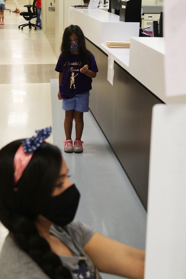 Olivia Garcia, 4, daughter of Jayme Mancera and Sgt. 1st Class Pablo Garcia, an observer, coach and trainer with Scorpion Team, Operations Group, identifies shapes July 29 during the vision station of back-to-school physicals at Weed Army...