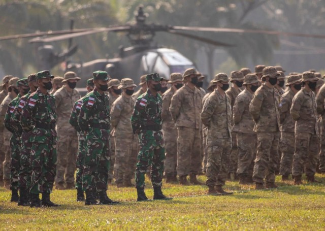 U.S. Army and Indonesian Army Soldiers, stand together during the opening ceremony for Garuda Shield 21 at the Baturaja Training Area, on August 4, 2021. Garuda Shield 21 is a two-week joint-exercise between the United States Army and Tentara Nasional Indonesia (TNI-AD Indonesia Armed Forces). The purpose of this joint-exercise is to enhance and enrich the jungle warfare ability of both the U.S. Army and Indonesian Army. (U.S. Army photo by Ssg. Thomas Calvert)