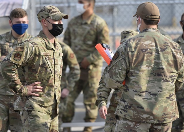 Air Force Airman 1st Class William Watson from the 2nd Logistics Readiness Squadron at Barksdale Air Force Base, Louisiana, discusses his results with one of the 368th Training Squadron ground transportation instructors after competing in the 10K...