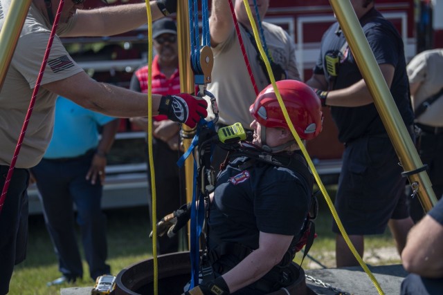 Rebecca Woollard, fire inspector with the Fort Jackson Fire Department, is lowered into a tunnel to rescue a notional patient as part of confined space rescue training July 16. This training is an annual requirement to maintain certification.