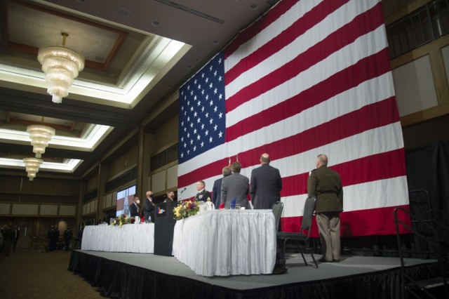 Staff Sgt. Richard Scarlett of the Maneuver Center of Excellence Band (Fort Benning, Ga.) sings the National Anthem at the podium during the annual Armed Forces Celebration Luncheon hosted by the Huntsville/Madison County Chamber Aug. 4 at the Von...