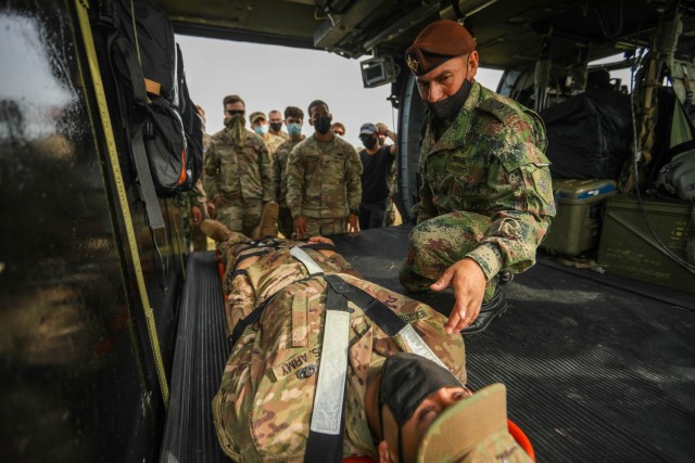 Colombian army soldier instructs U.S. Army medics assigned to 2nd battalion, 501st Parachute Infantry Regiment, 1st Brigade Combat Team, 82nd Airborne Division during a medical rehearsal, July 24, 2021, at Tolemaida Air Base, Colombia. The rehearsal was in preparation for the combined Dynamic Force Employment airborne exercise known as Exercise Hydra II. (U.S. Army photo by Pfc. Joshua Taeckens)
