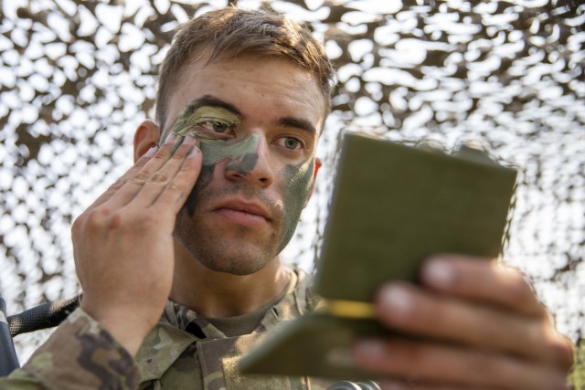 U.S. Army Spc. Omar Dacosta, a Soldier assigned to U.S. Army Forces, U.S. Central Command, applies camouflage face paint before conducting Warrior Tasks and Battle Drills during the 2021 FORSCOM Best Warrior Competition, Aug. 3, 2021, at Fort...