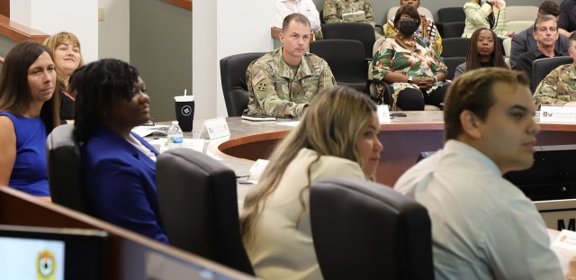 Brig. Gen. Gardner, commander of Joint Munitions Command, Mrs. Fisher, Deputy to the Commander, and CSM Morrison,  listen to an intern discuss project findings during the Minority College Relations Program brief to JMC and Army Contracting Command senior leaders July 20 (U.S. Army photo by Shawn Eldridge).