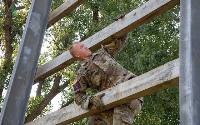 Sgt. Hunter Wilson, a noncommissioned officer assigned to III CORPS, climbs up the &#34;Confidence Climb&#34; portion of the Obstacle Course event during the first day of the 2021 Forces Command Best Warrior Competition at Fort Riley KS., Aug 2, 2021. Thirteen noncommissioned officers and twelve Soldiers are competing in a five-day competition representing the best in U.S. Army Forces Command at Fort Riley, KS., Aug 2-6. 