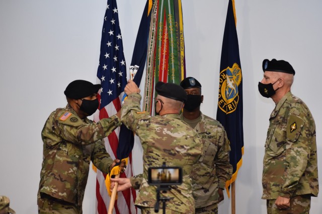 Army Chief of Chaplains, Chap. (Maj. Gen.) Thomas Solhjem passes the colors to new Chaplain School commandant, Chap. (Col.) James Palmer, Jr. July 30. Solhjem officiated the change of commandant ceremony between Palmer and outgoing commandant, Chap. (Col.) Bryan J. Walker. 