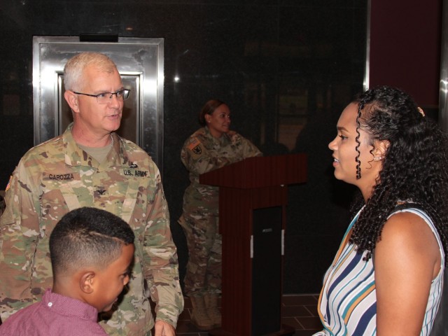 Col. Steven Carozza (left), U.S. Army Tank-automotive and Armaments Command chief of staff, chats with Angelyn Baldwin (right), wife of incoming Headquarters and Headquarters Company commander Capt. Jose Baldwin, at his Change of Command ceremony at the Detroit Arsenal, Michigan Jul. 23. 