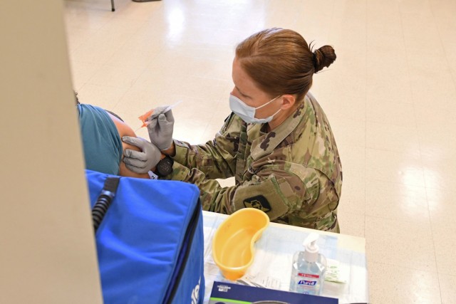 Maj. Christyn Gaa, a Critical Care Clinical Nurse at Tripler Army Medical Center administers a Pfizer COVID-19 vaccine at the joint-service event on July 16, 2021. The joint-service event was staffed by medical staff from Navy Medicine Readiness and Training Command Pearl Harbor and Tripler Army Medical Center. The free event kicked off on July 16 and will run for four weekends in July and August from 9 am to 2 pm. All TRICARE beneficiaries, as well as government civilians and non-appropriated fund (NAF) employees are eligible to receive their vaccine at the event.