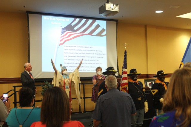 Buffalo Soldiers of the 9th and 10th (Horse) Cavalry display the colors during the playing of the national anthem Aug. 5, 2021, at City Hall in Lawton, Oklahoma. To the right of Lawton Mayor Stan Booker, Lauren Ashley Noriega signs the anthem’s...