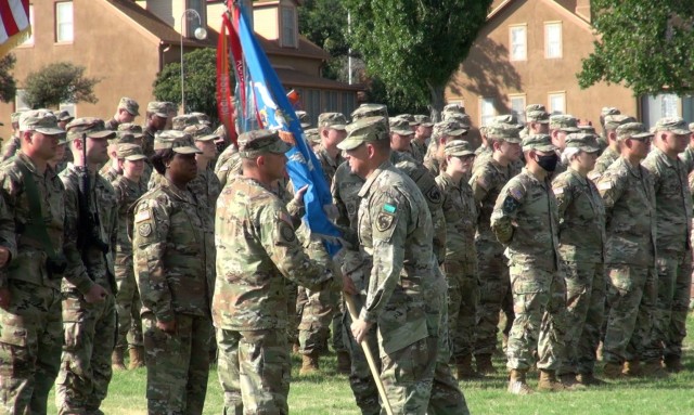Lt. Col. Robert Richardson, Commander, 304th Military Intelligence Battalion passes the unit colors to his incoming  Command Sgt. Maj. Matthew Hobbs at a Change of Responsibility ceremony at Fort Huachuca, Ariz.