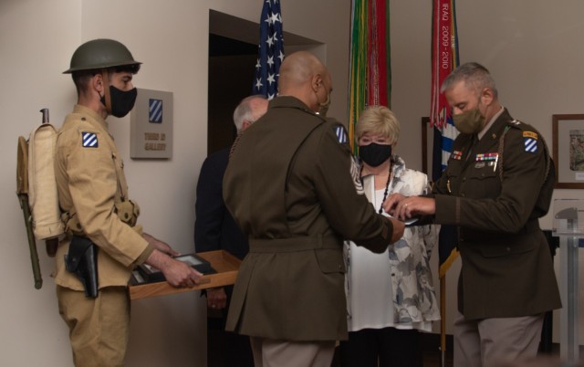 U.S. Army Maj. Gen. Charles Costanza, commanding general of the 3rd Infantry Division, bestows the Purple Heart Medal to Family members of 1st Lt. Thomas Beasley at Fort Stewart, Georgia, Aug 9, 2021. Beasley, a World War I Soldier killed in action, received his posthumous awards during a special ceremony at Fort Stewart to honor his service and sacrifice.(U.S. Army photo by Pvt. Elsi Delgado, 50th Public Affairs Detachment)