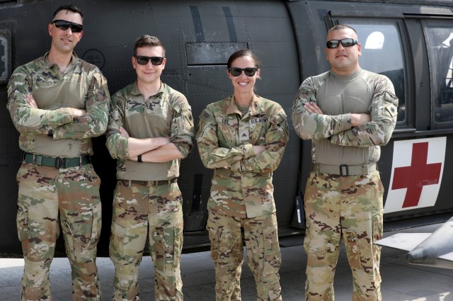 A Task Force Phoenix MEDEVAC crew from G Company, 1st Battalion, 168th Aviation Regiment (General Support Aviation Battalion), known as DUSTOFF, poses for a photo at Camp Buehring, Kuwait. The fully vaccinated crew took extra precautions during a...
