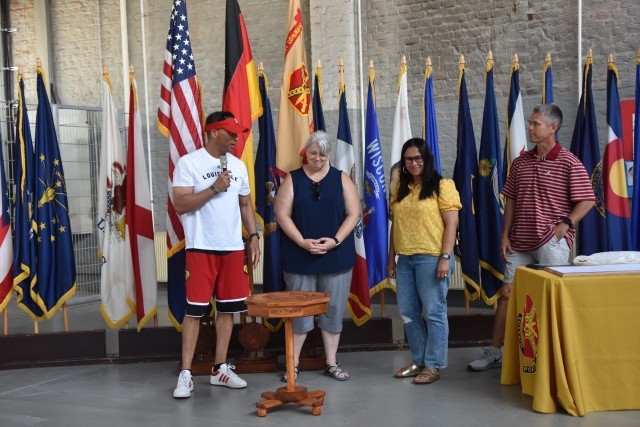 Gwyn Truchon, wife of the Wiesbaden Command Sgt. Maj., received a special thank you gift of a hand-carved table, from the spouses club, as Garrison Commander Col. Mario Washington, his wife, Elizabeth and Command Sgt. Maj, Chris Truchon look on.