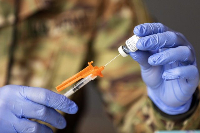 U.S. Army Soldiers draw and prepare vaccines at the Atlanta Community Vaccination Center in the Mercedes-Benz Stadium, March 26, 2021. U.S. Northern Command, through U.S. Army North, remains committed to providing continued, flexible Department of...