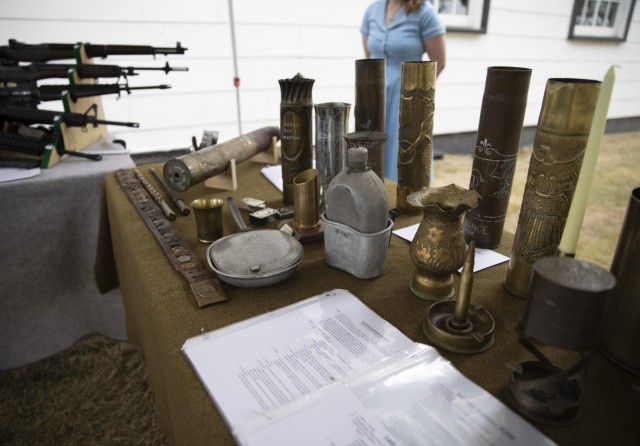 Alli Krisco, a living historian from Spanaway, WA displays Trench Art at the Lewis Army Museum reopening at Joint Base Lewis-McChord, Wash., July 31, 2021. Many soldiers during World War I created art pieces using artillery shells to pass the time...