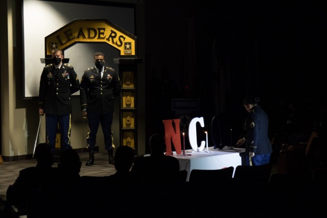 Staff Sgt. Andrea M. Villela, a cargo specialist assigned to the 403rd Inland Cargo Transportation Company, lights a candle during 3rd Expeditionary Sustainment Command’s noncommissioned officer corps induction ceremony, Aug. 5, 2021, on Fort Bragg, North Carolina. 3rd ESC inducted 49 soldiers during the ceremony.