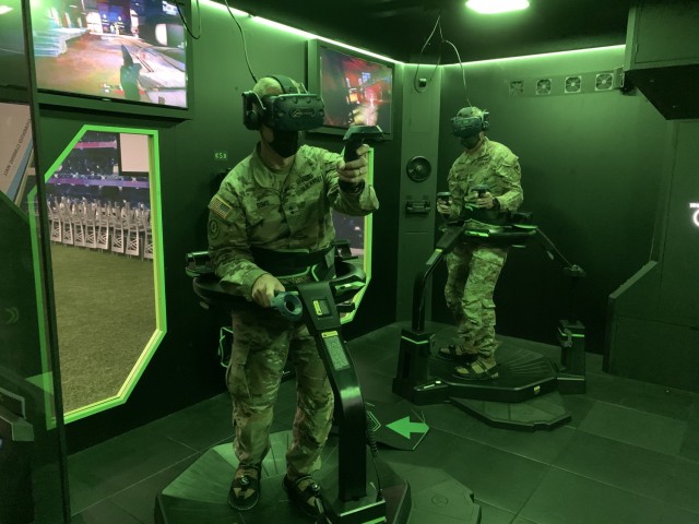 Maj. Gen. D. A. Sims II, Commanding General of the 1st Infantry Division, left, and Col. William B. McKannay, U.S. Army Garrison Fort Riley Commander, try out the Omni Arena virtual reality gaming system at SpareTime Interactive Entertainment, Fort Riley, Kansas, Aug. 5, 2021.