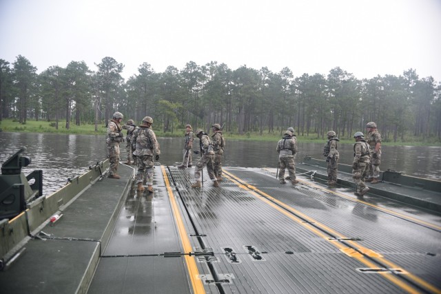 Soldiers from the 926th Engineer Brigade work tirelessly on a buoyant raft to construct a bridge for military vehicles on 20 July at Fort Stewart, Ga.