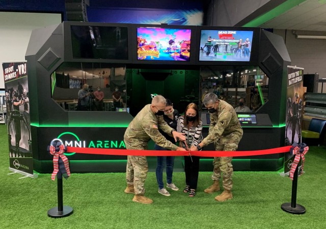 From left to right, Maj. Gen. D. A. Sims II, Commanding General of the 1st Inf. Div.; Selena Gonzalez, operations assistant, and Tracy Locklear, business manager, Fort Riley’s SpareTime Interactive Entertainment, Directorate of Family and Morale, Welfare and Recreation; and Col. William B. McKannay, U.S. Army Garrison Fort Riley Commander, cut the ribbon at the grand opening ceremony for the Omni Arena virtual reality gaming system at SpareTime Interactive Entertainment, Fort Riley, Kansas, Aug. 5, 2021.