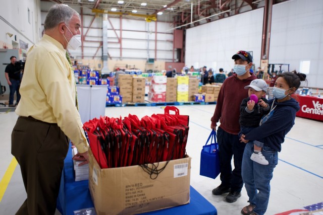 JOINT BASE ELMENDORF-RICHARDSON, Alaska -- Alaska Army National Guard Spc. Aaron Olson, wife, Andrea, and son, Greyson, meet with Employer Support of the Guard and Reserve representative Don Black during a Commissary sale Aug. 7, 2021, at the...