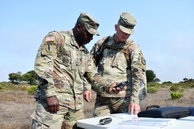 Sgts. 1st Class Aaron Reynolds, left, and Michael Turner, assigned to the 229th Military Intelligence Battalion, confirm grid coordinates before the start of battalion’s land navigation competition at Fort Ord National Monument, Calif., Aug. 7.,...