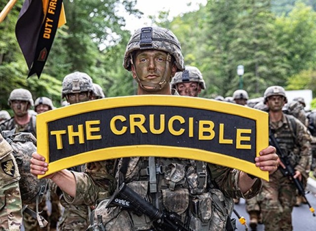 A new cadet from the U.S. Military Academy Class of 2025 carries a sign, ʻThe Crucible,ʼ as his classmates complete the final mile of March Back Monday at West Point.