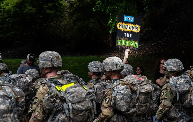 A family member of a Class of 2025 cadet holds a sign congratulating the new cadets on ʻSlaying the Beastʼ as they complete their initial summer training at West Point.