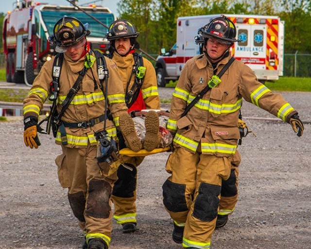 Firefighters Drew Wilson, Ryan Harrell and Jake Haynes, Fort Campbell Fire Department, use a litter to carry a wounded Soldier May 2018 during a full-scale exercise on post. The exercise was conducted to evaluate Fort Campbell’s emergency...
