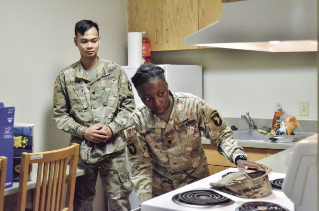 Specialist Arianna Holt, 1st Battalion, 101st Aviation Regiment, 101st Combat Aviation Brigade, 101st Airborne Division (Air Assault), inspects a barracks room July 29 as Spc. Brandon Antolin, 96th Aviation Support Battalion, 101st CAB, prepares...