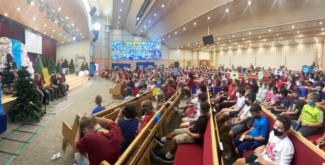At the end of day three, Mackenzie Laminack, worship leader for Humphreys Vacation Bible School, welcomes back VBS participants for more singing and dancing before they leave,  Aug. 11, at the Four Chaplains Memorial Chapel.  (Photo by Monica K....