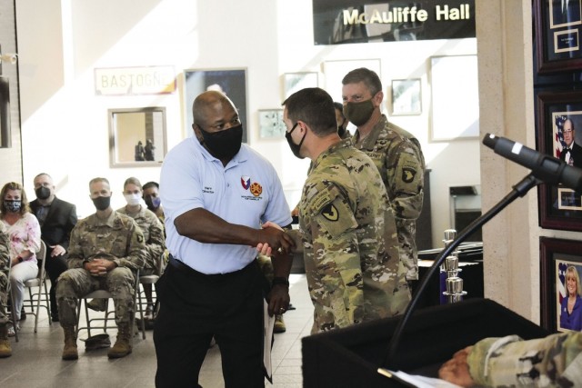 Harvey Jones, director of the Installation Safety Office, shakes the hand of Col. Andrew Q. Jordan, Fort Campbell garrison commander, while Maj. Gen. JP McGee, commanding general of the 101st Airborne Division (Air Assault) and Fort Campbell,...
