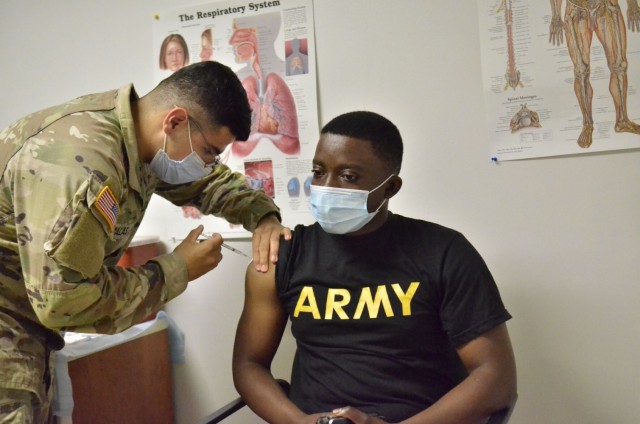 Specialist Derick Kameni, 326th Brigade Engineer Battalion, 1st Brigade Combat Team, 101st Airborne Division (Air Assault) receives his first dose of the COVID-19 vaccine May 19 from Pvt. Raul Salas, 1st Battalion, 327th Infantry Regiment, 1st BCT, at the 326th BEB Aid Station. Kameni had previously opted out of the vaccine but decided to take the shot after attending a briefing at Snipes Dining Facility.