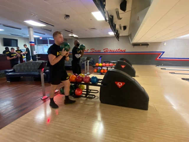 Spc. Dean Vanderbush (left) and Staff Sgt. Freddie Gardner (right) participated in an adaptive reconditioning bowling event on July 14 at the Fort Sam Houston Bowling Center. They are assigned to the Joint Base San Antonio-Fort Sam Houston Soldier Recovery Unit, Texas. (Photo courtesy of Cris Durham)