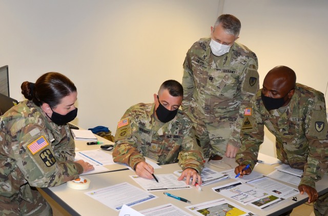 VICENZA, Italy (Aug. 10, 2021) – 414th Contracting Support Brigade Maj. Julio Fernandez, contracting team lead, second from the left, formulates a plan of action during the evaluation exercise held on Caserma Ederle Aug. 10. The Army Contracting...