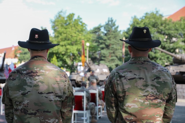 Capt. Kevin Noriega (left) and 1st Lt. Christopher Raymond with 1st Armored Brigade Combat Team, 1st Cavalry Division, attend the transfer of authority ceremony from 1ABCT, 1CD to 1ABCT, 1st Infantry Division, in Żagań, Poland, August 13, 2021. As of October 2020, 1ABCT, 1ID,  based out of Fort Riley, Kan., is the eighth rotation of an ABCT in support of Atlantic Resolve, funded by the European Deterrence Initiative, which enables the U.S. to enhance deterrence, increase readiness and support NATO. 